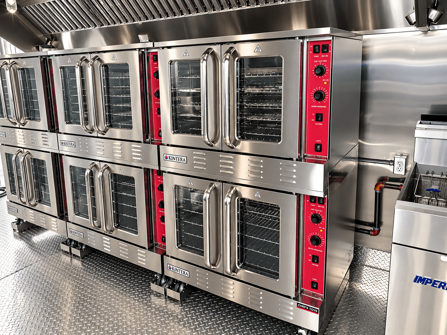 Bank of stacked commercial ovens inside a kitchen trailer