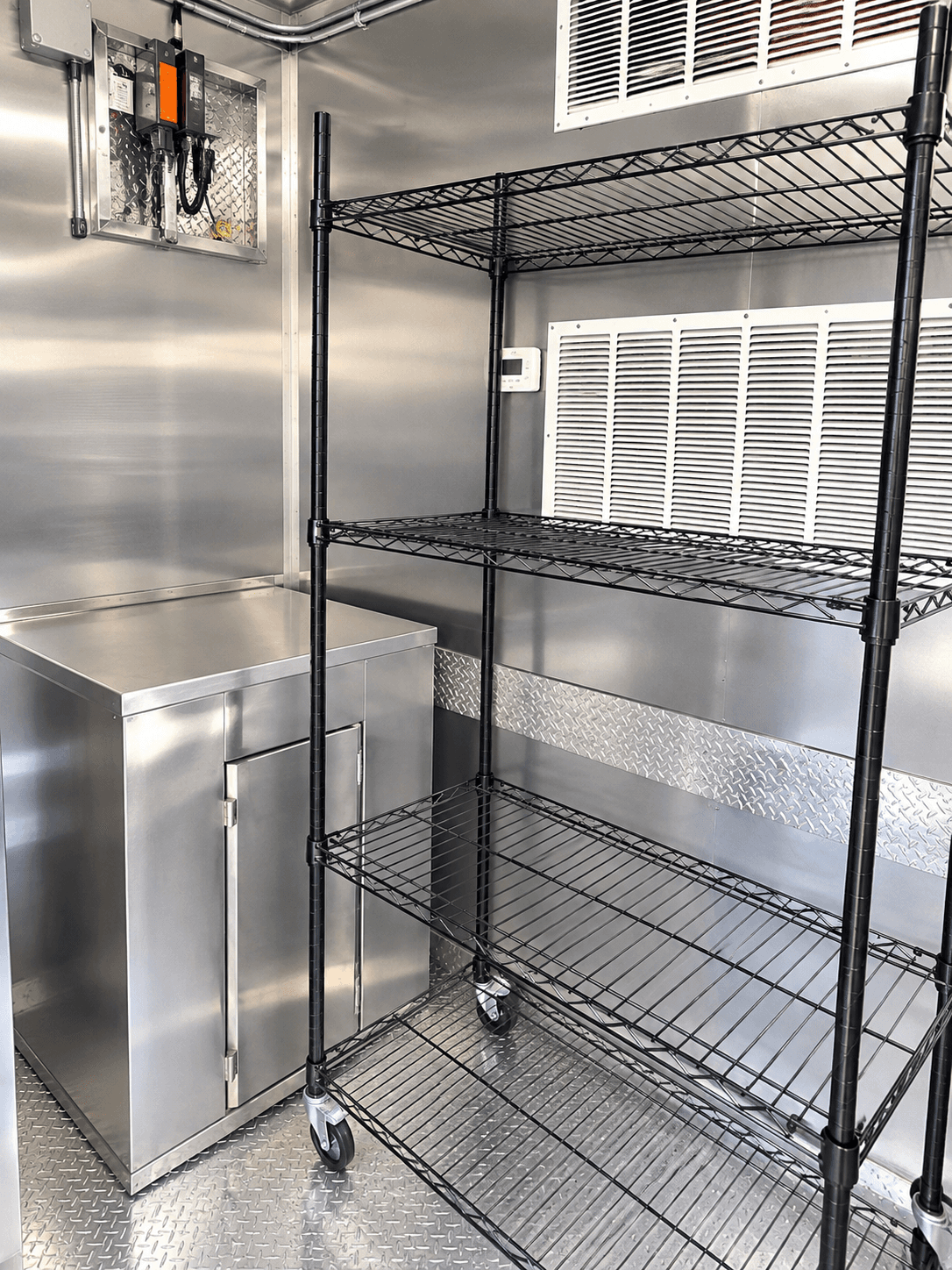 Storage shelving and open workspace inside a kitchen trailer